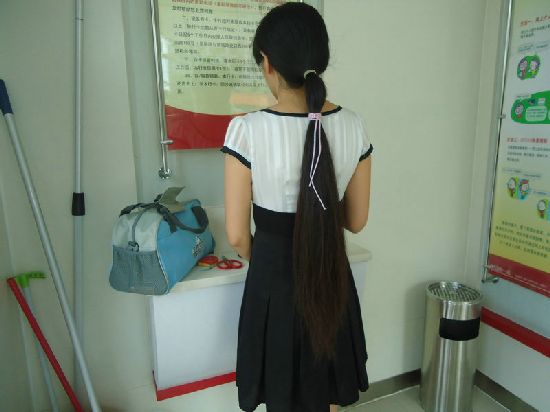 Young girl cut long ponytail